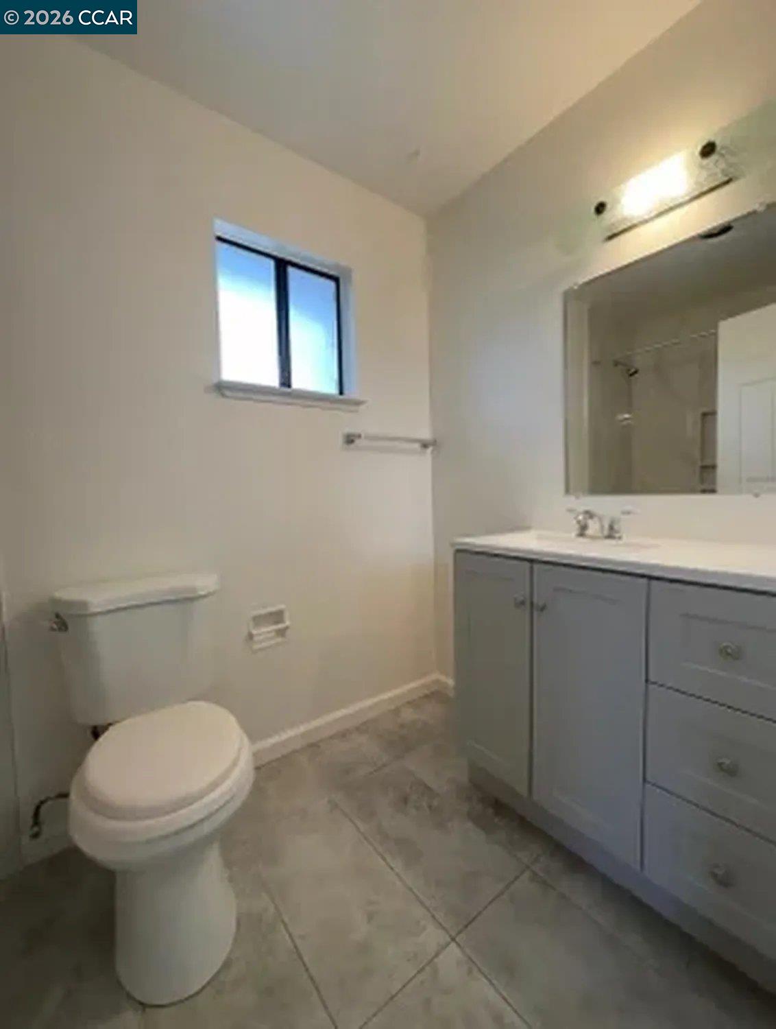 568 Dean Street Hayward, CA 94541 - Photo 10 of 17 a bathroom with a toilet sink and mirror