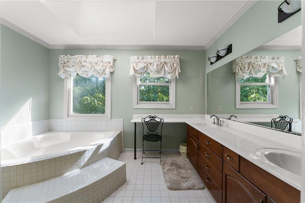 24 Commerce Row Northeast Cartersville, GA 30121 - Photo 19 of 37 a spacious bathroom with a tub double sink and mirror