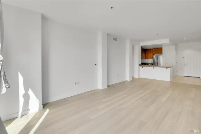 a view of a kitchen with a sink and a refrigerator