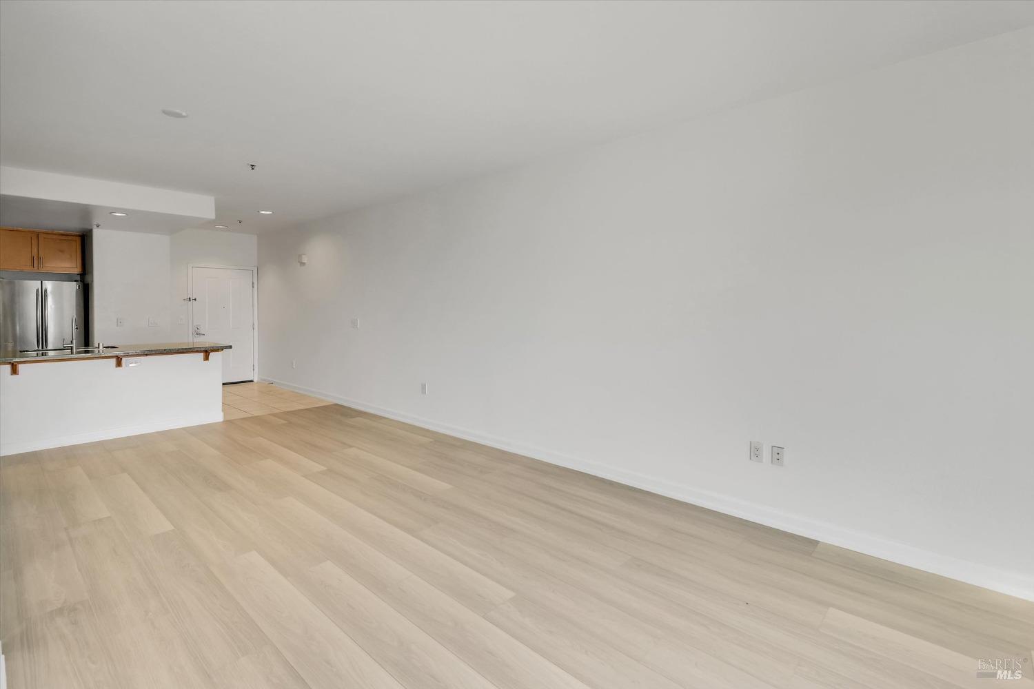 423 7th Street, Unit 105 Oakland, CA 94607 - Photo 16 of 28 a view of a kitchen with a sink and a refrigerator