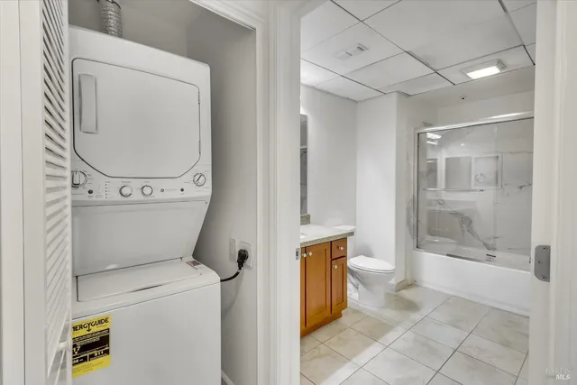 a bathroom with a granite countertop sink a toilet and shower