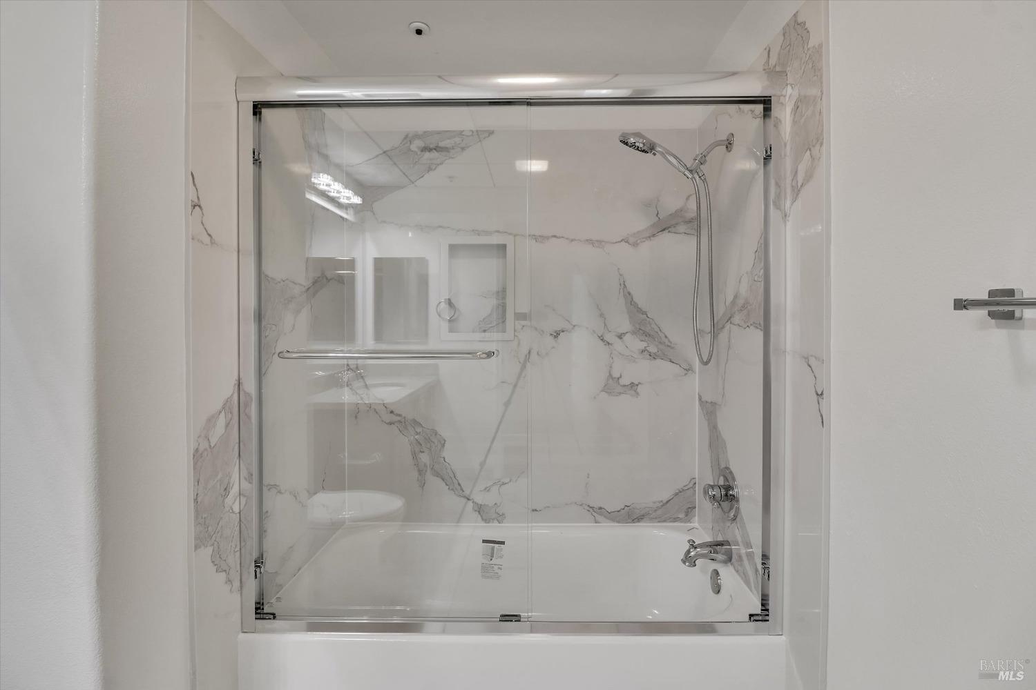 423 7th Street, Unit 105 Oakland, CA 94607 - Photo 24 of 28 a bathroom with a glass shower door