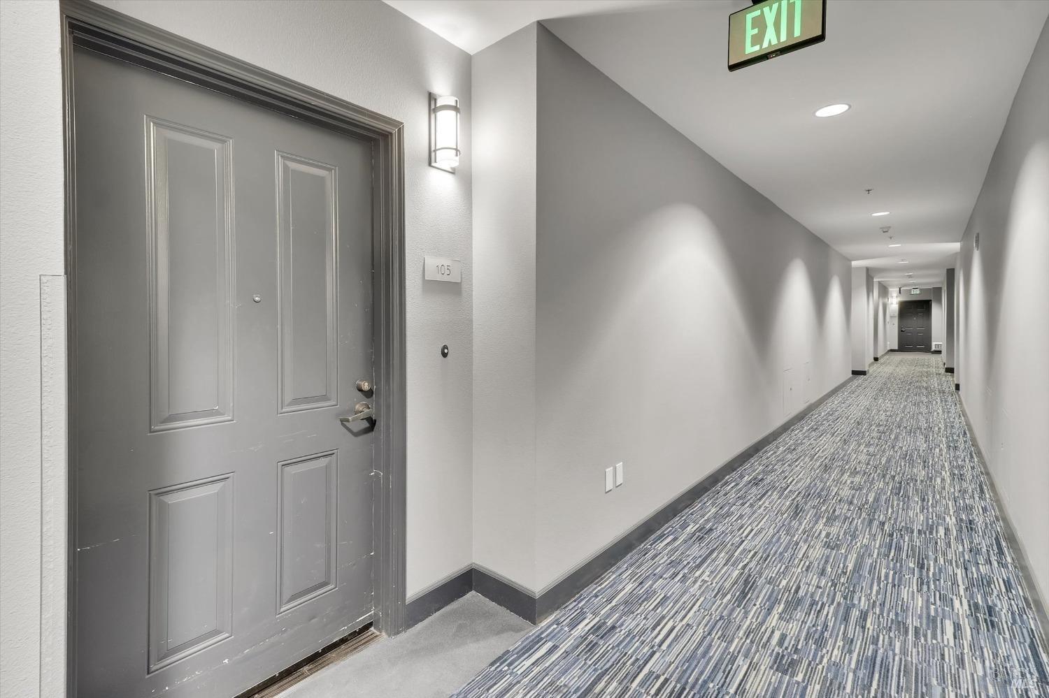 423 7th Street, Unit 105 Oakland, CA 94607 - Photo 5 of 28 a view of a hallway view with wooden floor and staircase