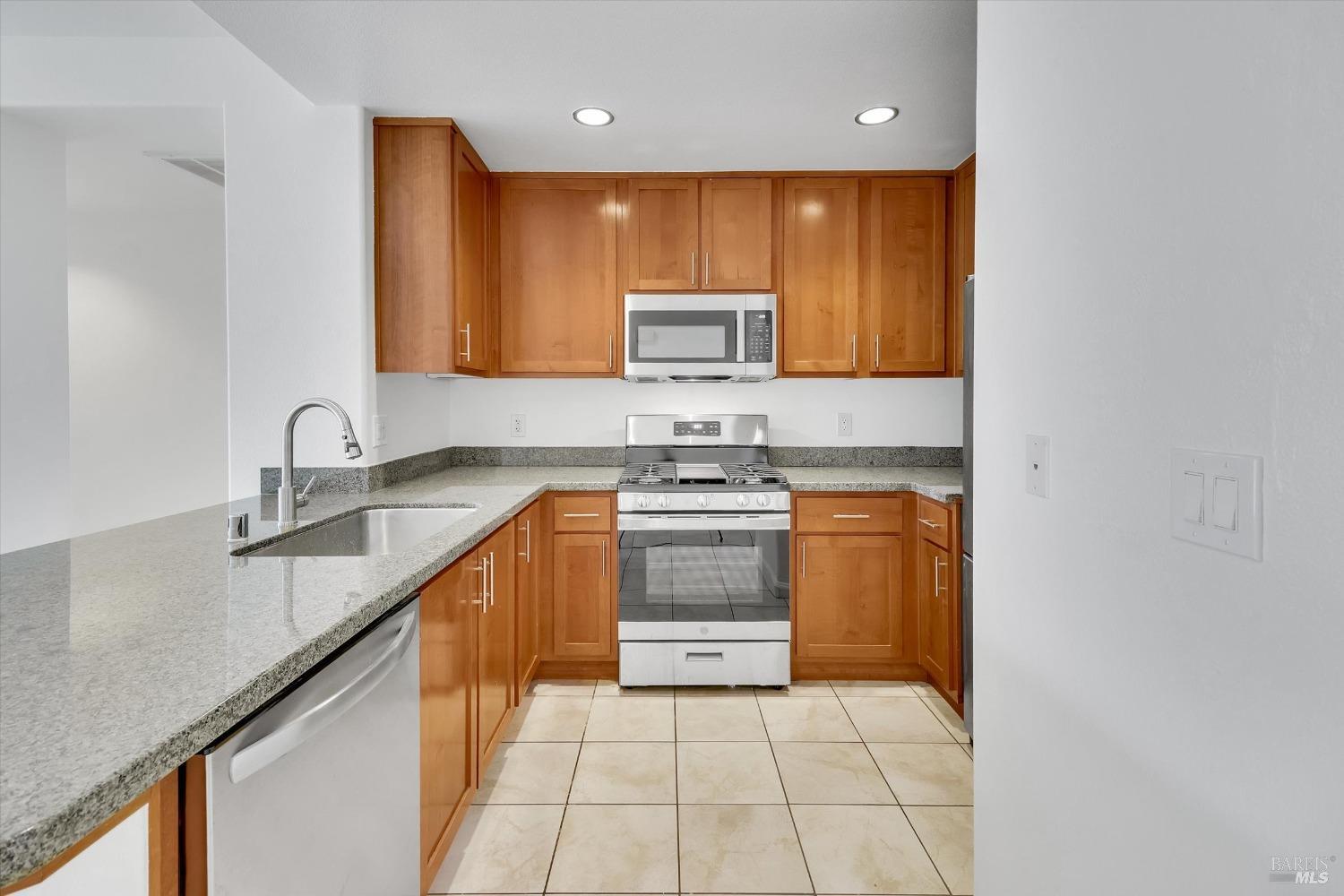423 7th Street, Unit 105 Oakland, CA 94607 - Photo 9 of 28 a kitchen with a sink stove and cabinets