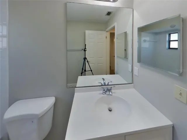 a bedroom with a large bed and a large window