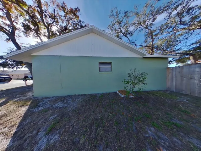 a view of a house with a yard and tree
