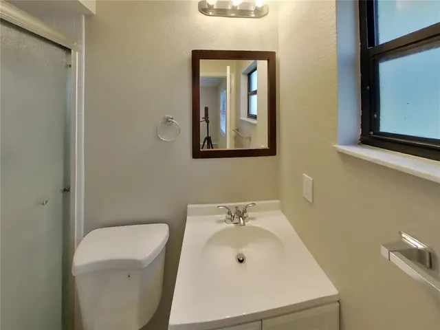 a bathroom with a glass shower door