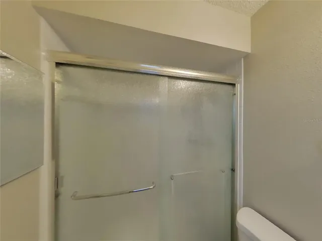 an empty room with closet and windows