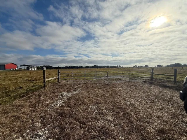 a view of a field with an outdoor space