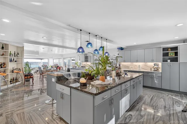 a kitchen with granite countertop a sink stove and cabinets