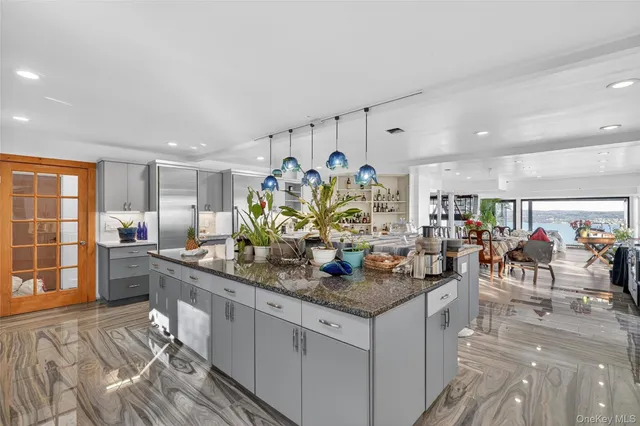 a kitchen with stainless steel appliances granite countertop a stove and cabinets