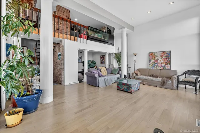 a living room with furniture and a potted plant