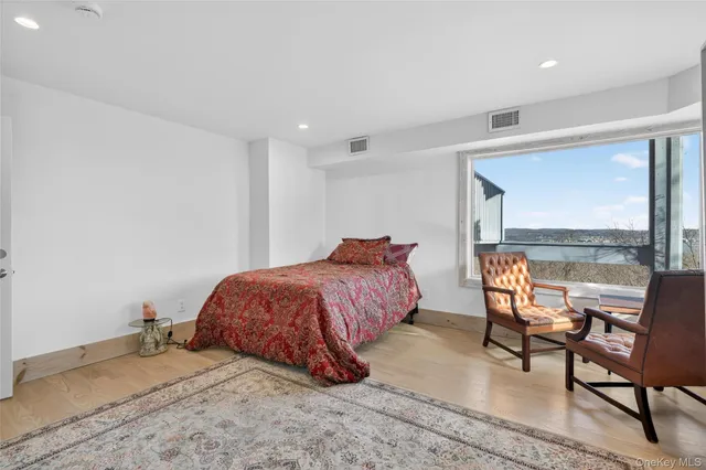 a spacious bedroom with a bed and a window