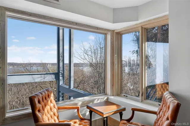 a living room with furniture a table and a large window