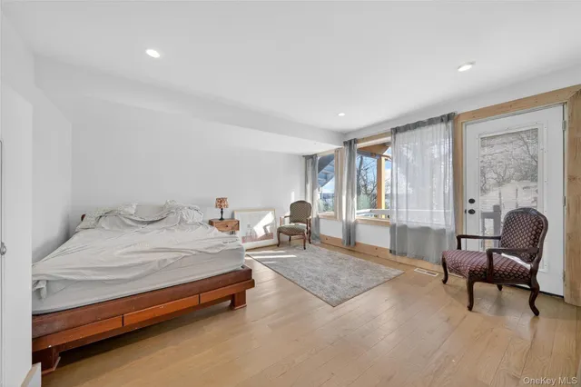 a bedroom with a bed chair and a window