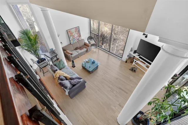 a living room with furniture and floor to ceiling window