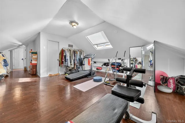 a living room with furniture and a gym equipment