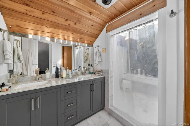 a bathroom with a double vanity sink and a mirror