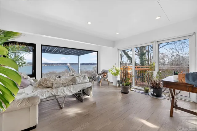 a bedroom with furniture and large windows