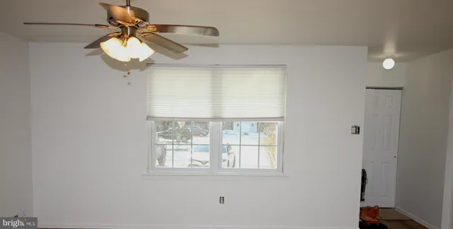 a view of a room that has a window and a fan