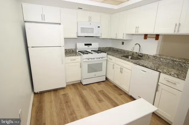 a kitchen with a sink a stove and refrigerator