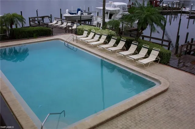 a view of a swimming pool with a table and chairs