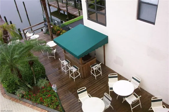 a front view of a house with a yard table and chairs