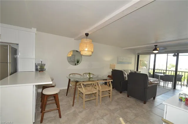 a dining room with furniture and a chandelier