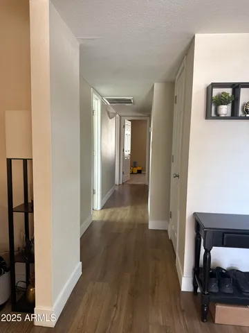 a view of a hallway with wooden floor