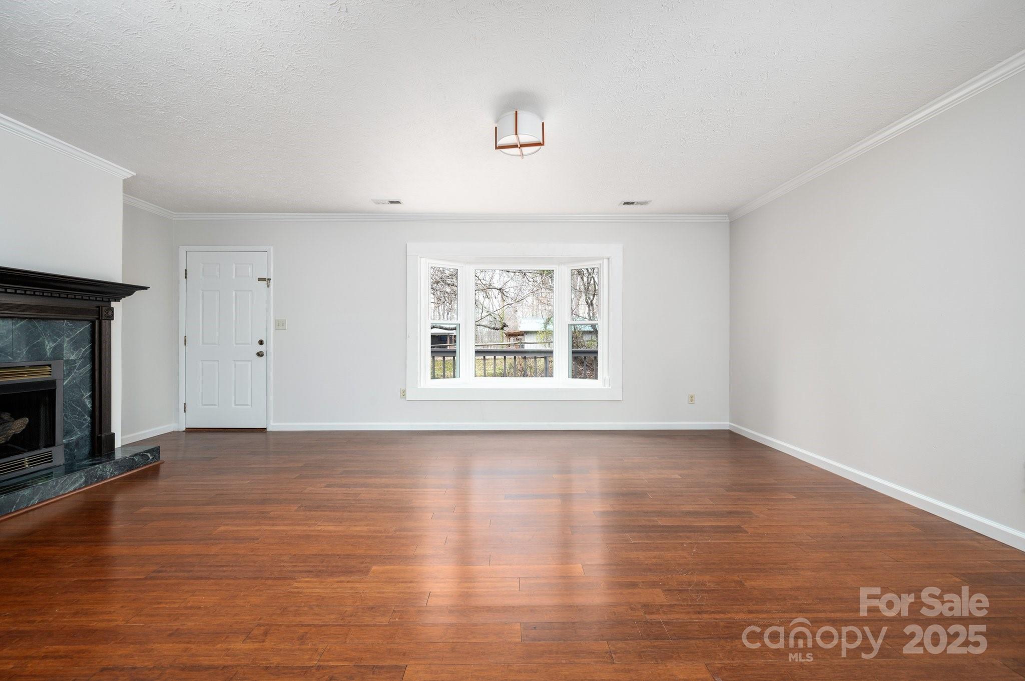 148 Pinecrest Drive Alexander, NC 28701 - Photo 11 of 31 a view of an empty room with a window and fireplace