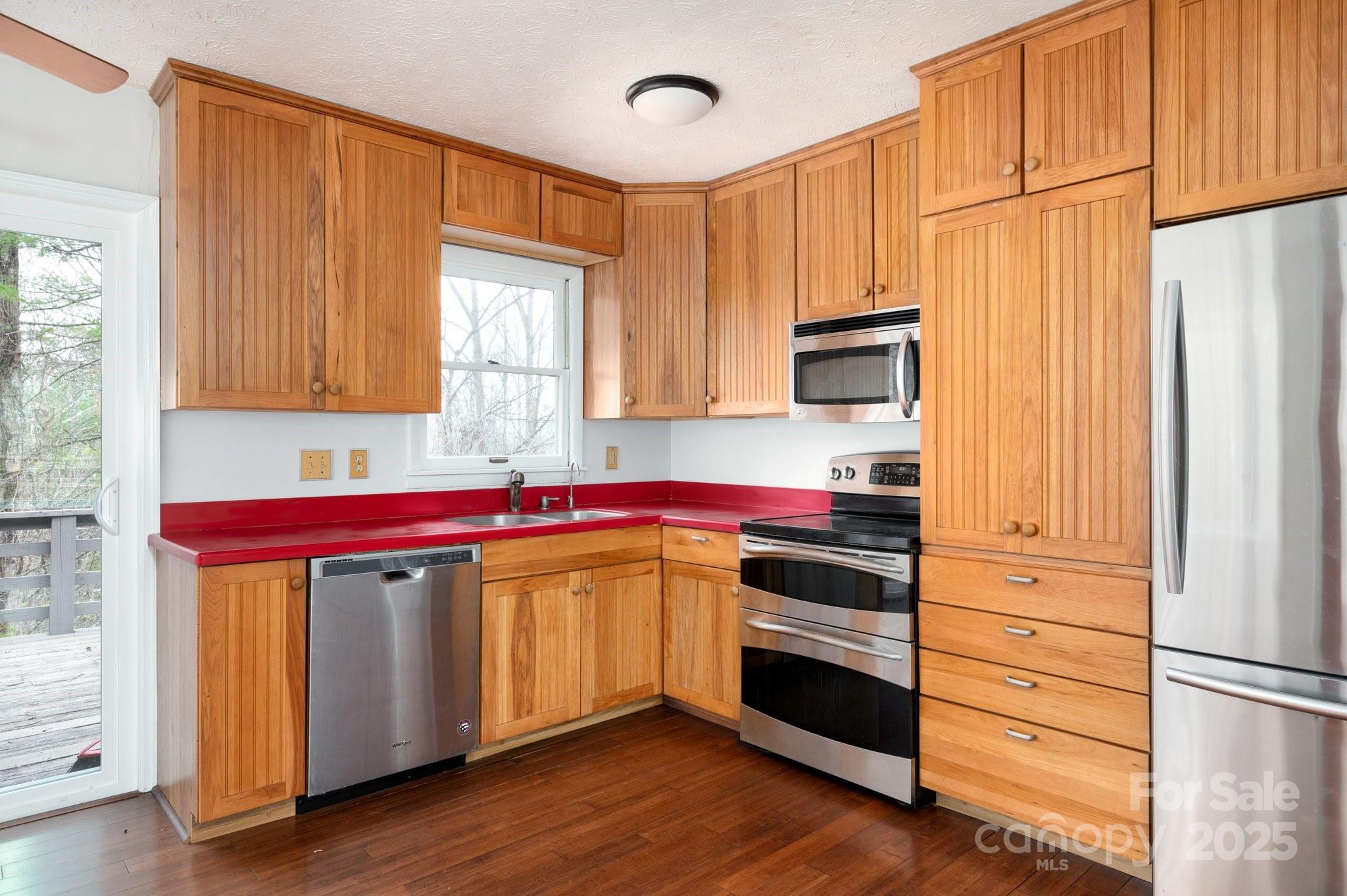 148 Pinecrest Drive Alexander, NC 28701 - Photo 15 of 31 a kitchen with stainless steel appliances granite countertop a stove and a refrigerator