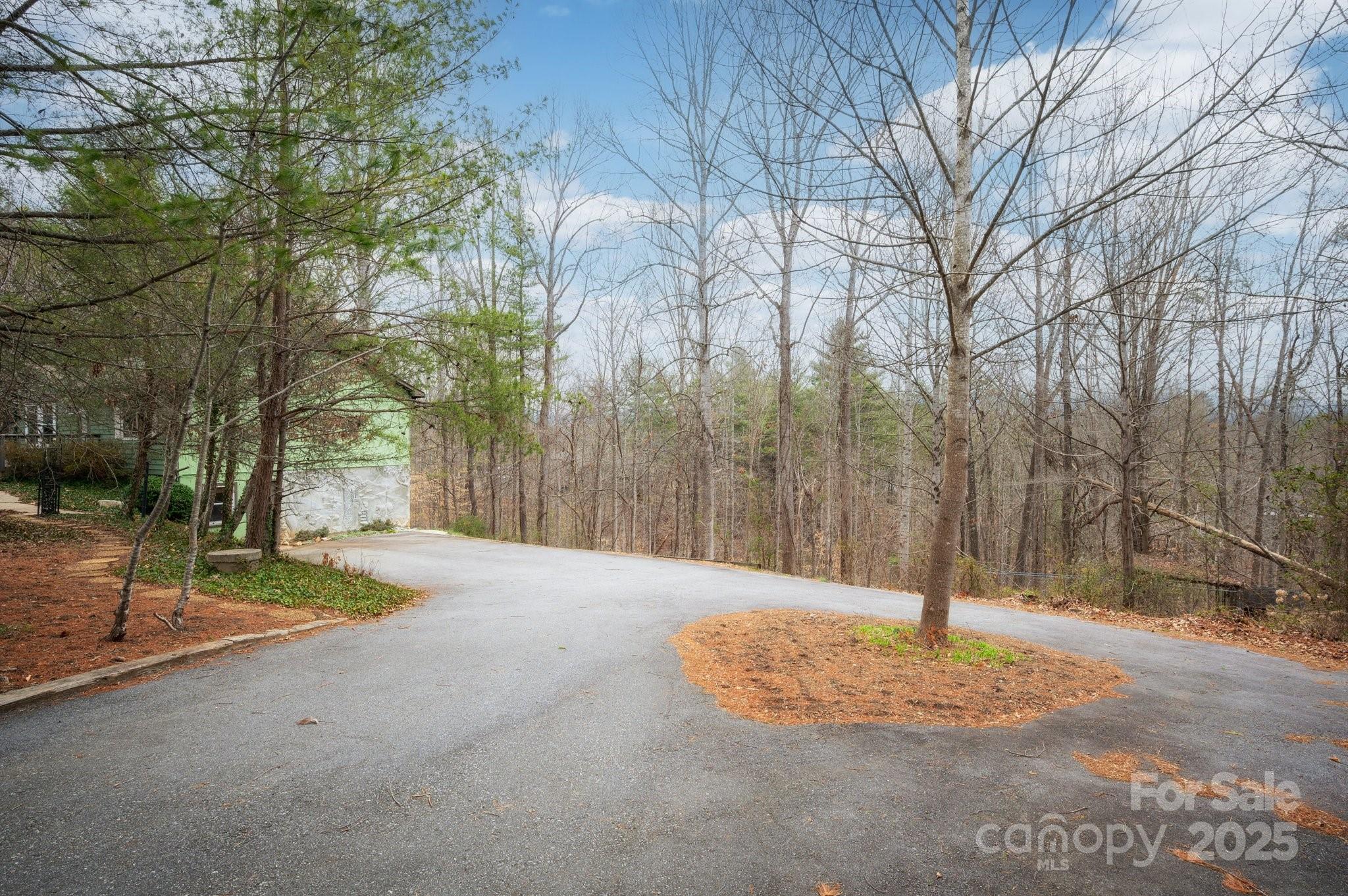 148 Pinecrest Drive Alexander, NC 28701 - Photo 2 of 31 a backyard of apartments with large trees
