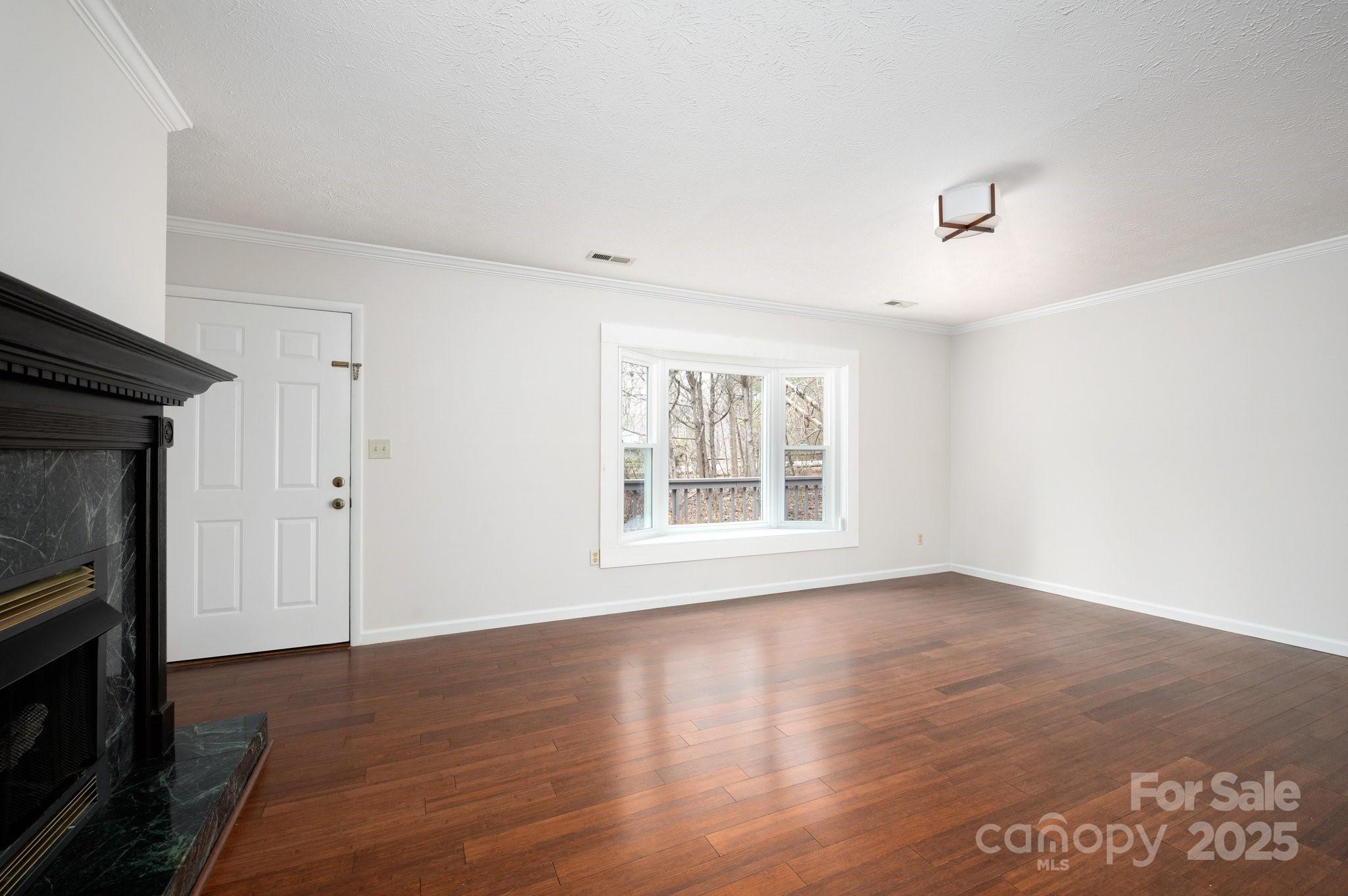 148 Pinecrest Drive Alexander, NC 28701 - Photo 10 of 31 a view of an empty room with wooden floor and a window