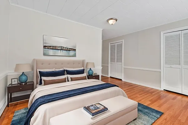 a bedroom with a bed and wooden floor