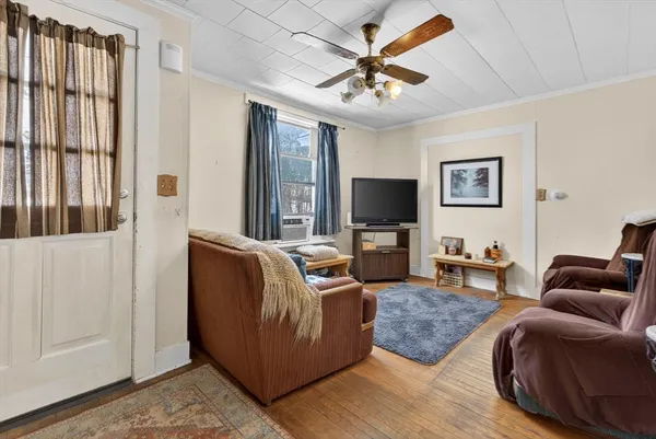 a living room with furniture and a flat screen tv