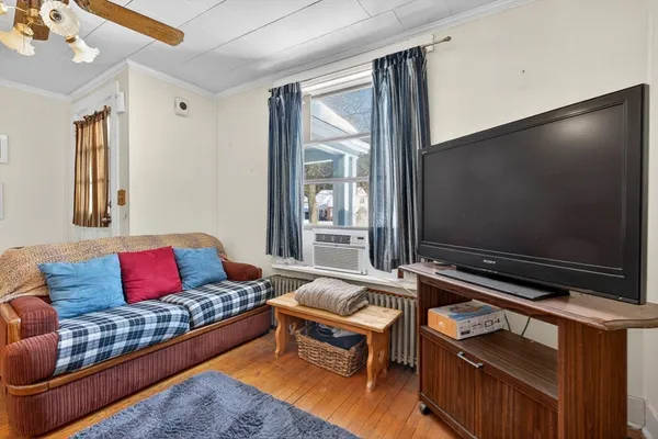 a living room with furniture and a flat screen tv