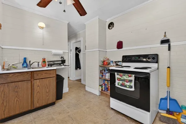 a kitchen with stove and cabinets