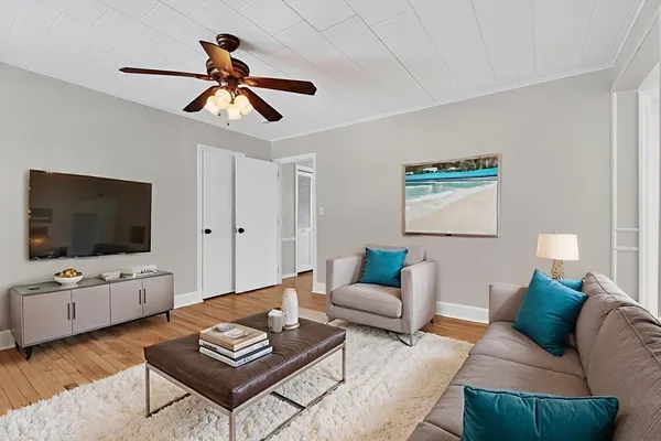 a living room with furniture and a flat screen tv