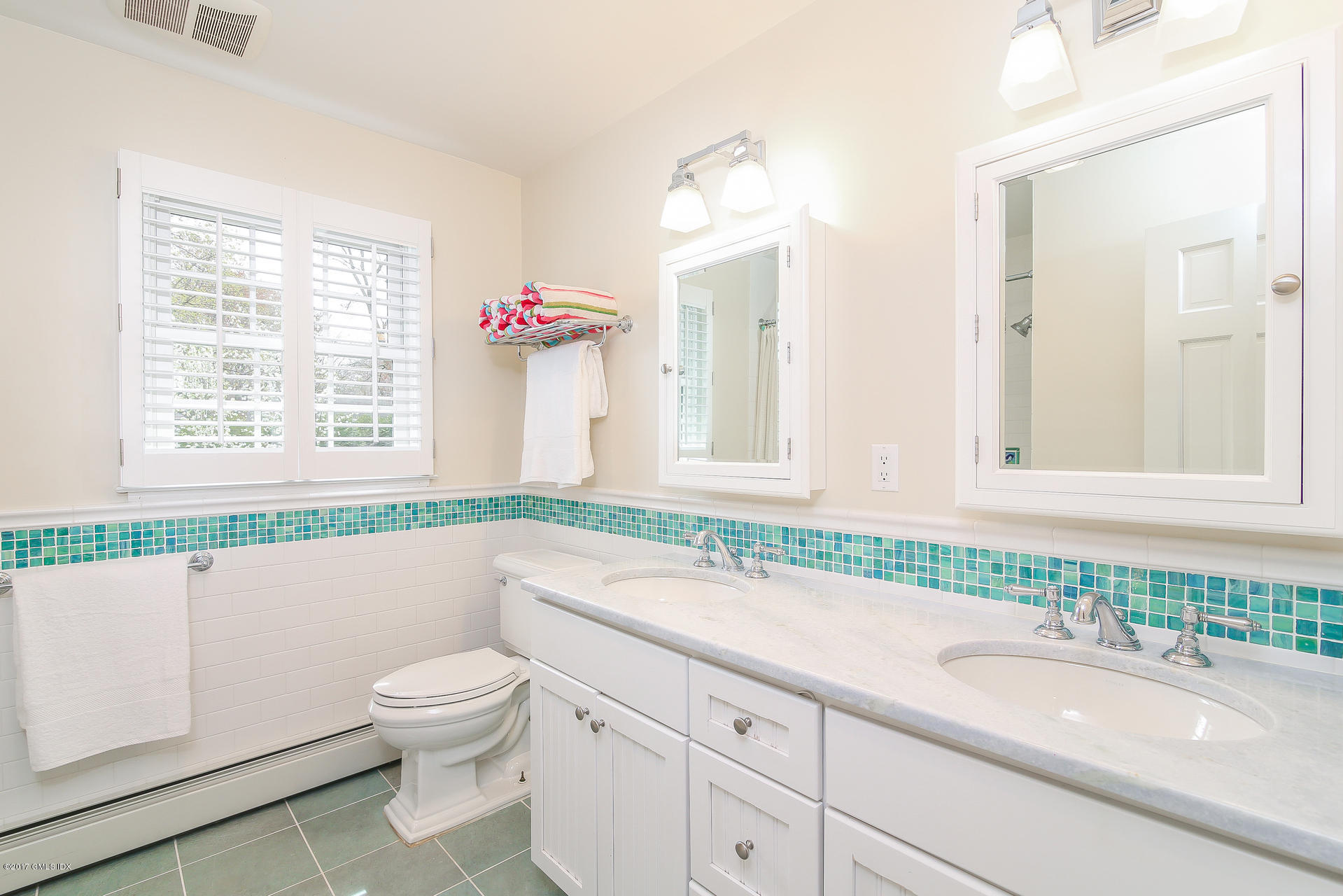 22 Griffith Road Riverside, CT 06878 - Photo 29 of 40 a bathroom with a granite countertop sink mirror vanity and a toilet