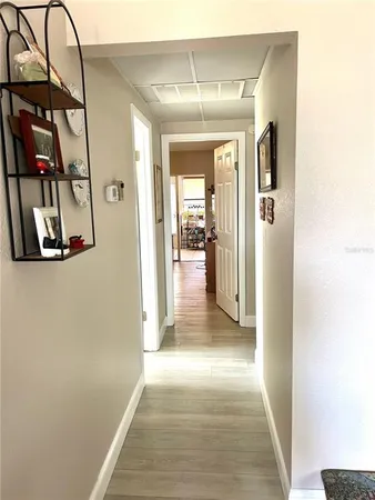 a view of a hallway with wooden floor and entryway