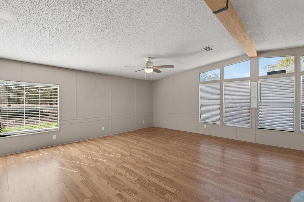 2744 Roy Sikes Road Hilliard, FL 32046 - Photo 36 of 97 a view of an empty room with a window and wooden floor