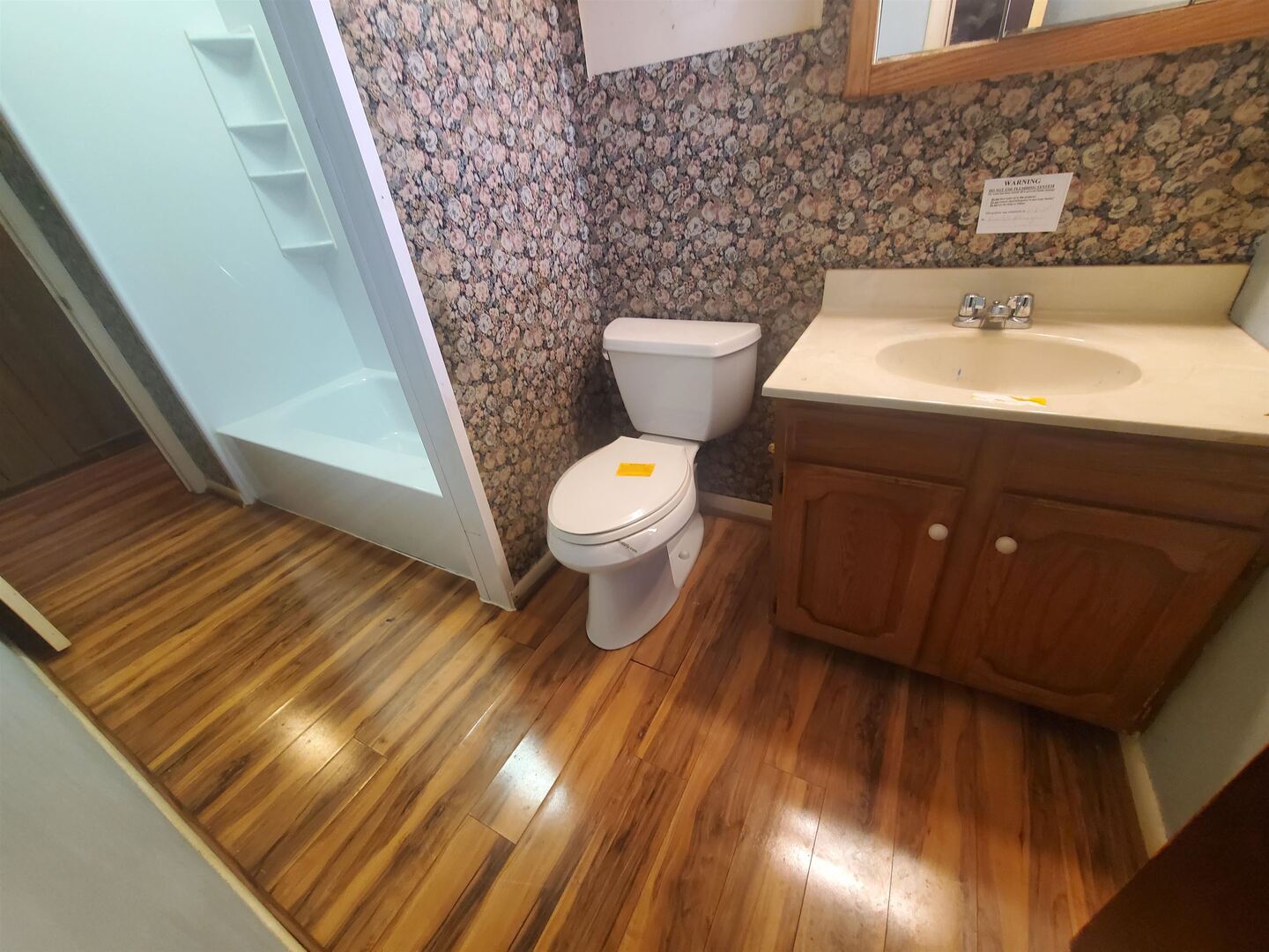 3305 3rd St A East Moline, IL 61244 - Photo 5 of 12 a bathroom with a toilet sink and mirror