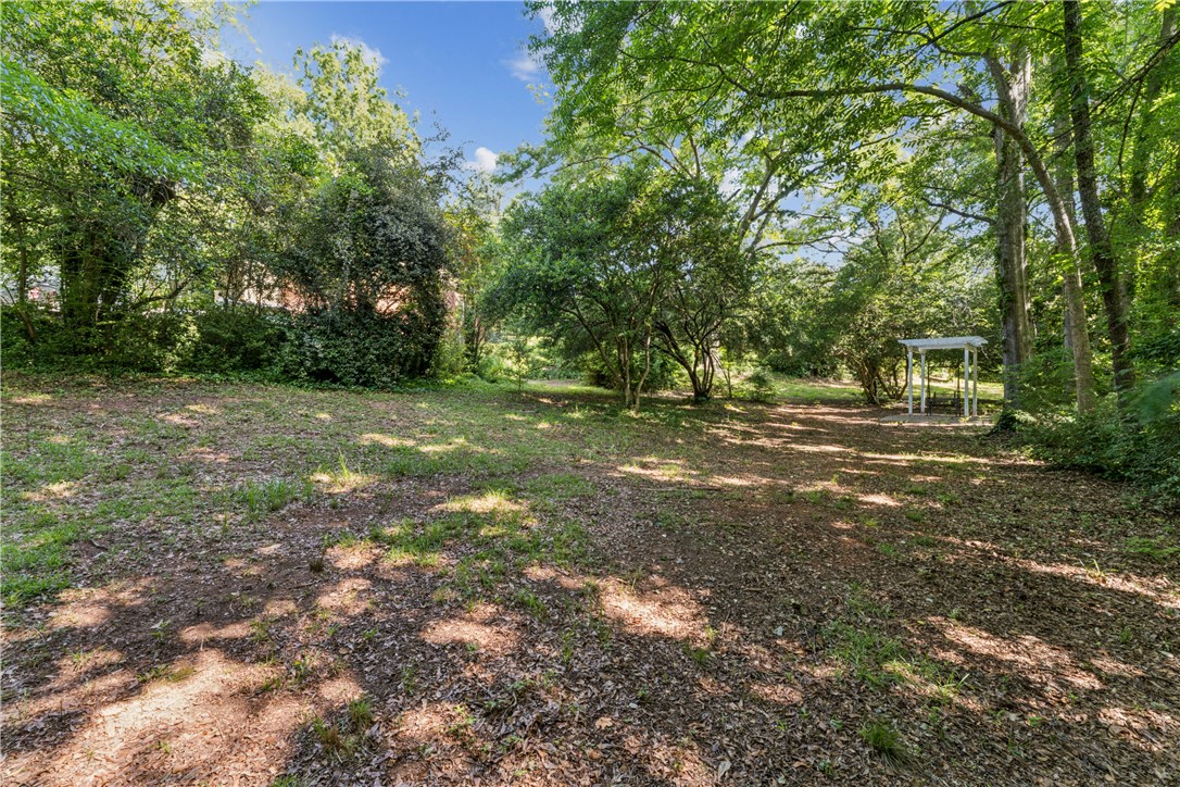 321 South Pine Street Walhalla, SC 29691 - Photo 28 of 28 A tranquil landscape offers a blend of natural greenery, featuring a quaint gazebo tucked amidst the trees.