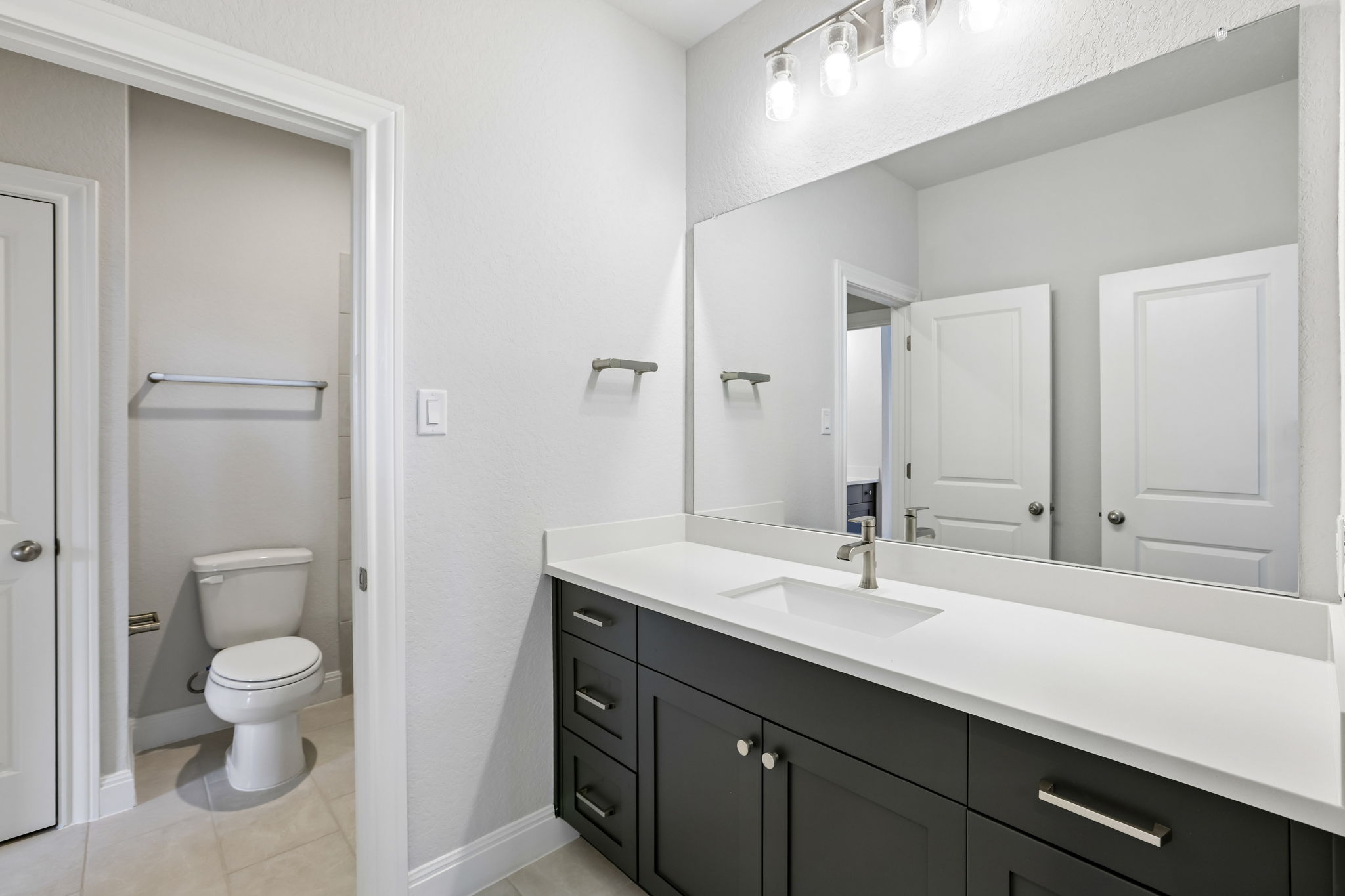 214 Prickly Poppy Loop Kyle, TX 78640 - Photo 28 of 38 a bathroom with a toilet sink and mirror