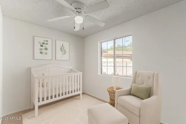 an empty room with windows and fan