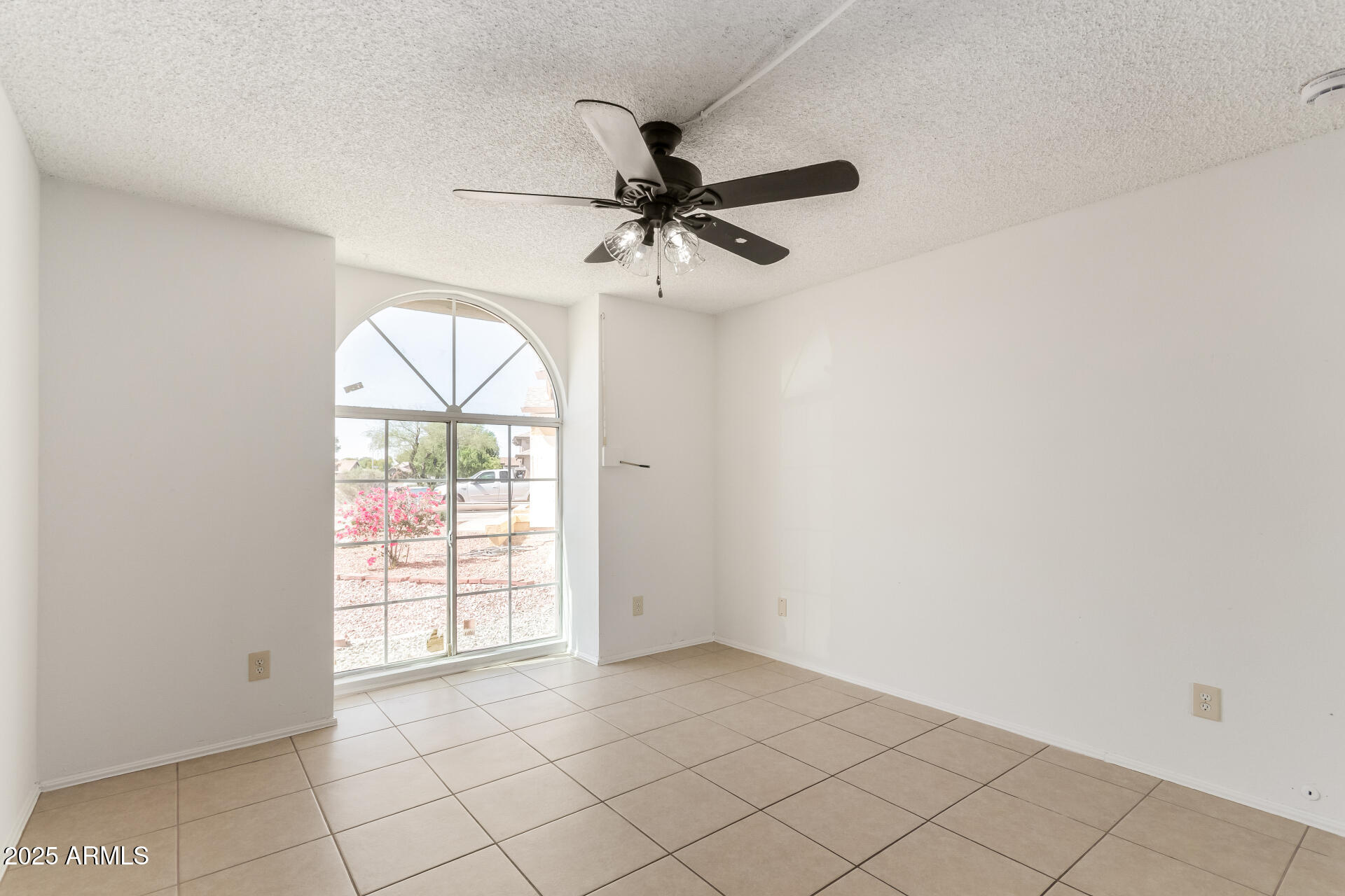 3419 North 70th Avenue Phoenix, AZ 85033 - Photo 19 of 31 an empty room with windows and fan