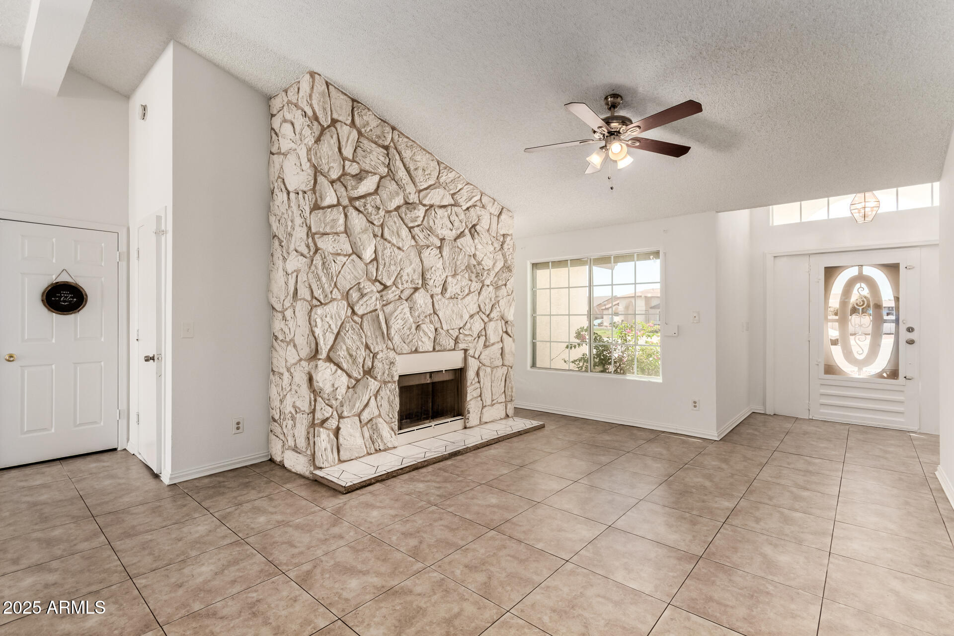 3419 North 70th Avenue Phoenix, AZ 85033 - Photo 4 of 31 an empty room with windows and fireplace
