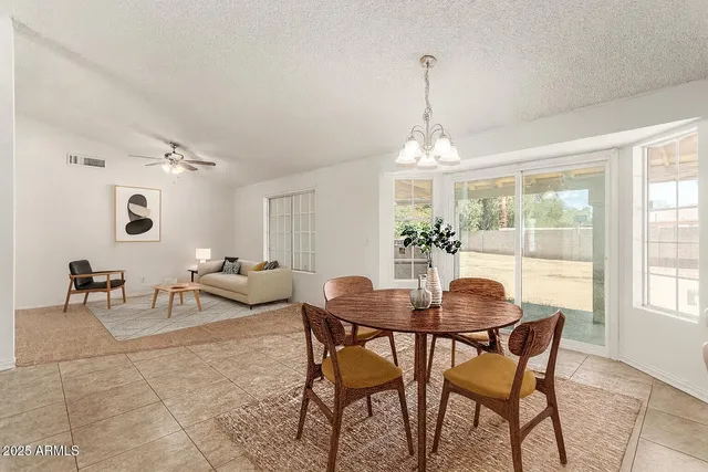 a view of a dining room with furniture and a chandelier