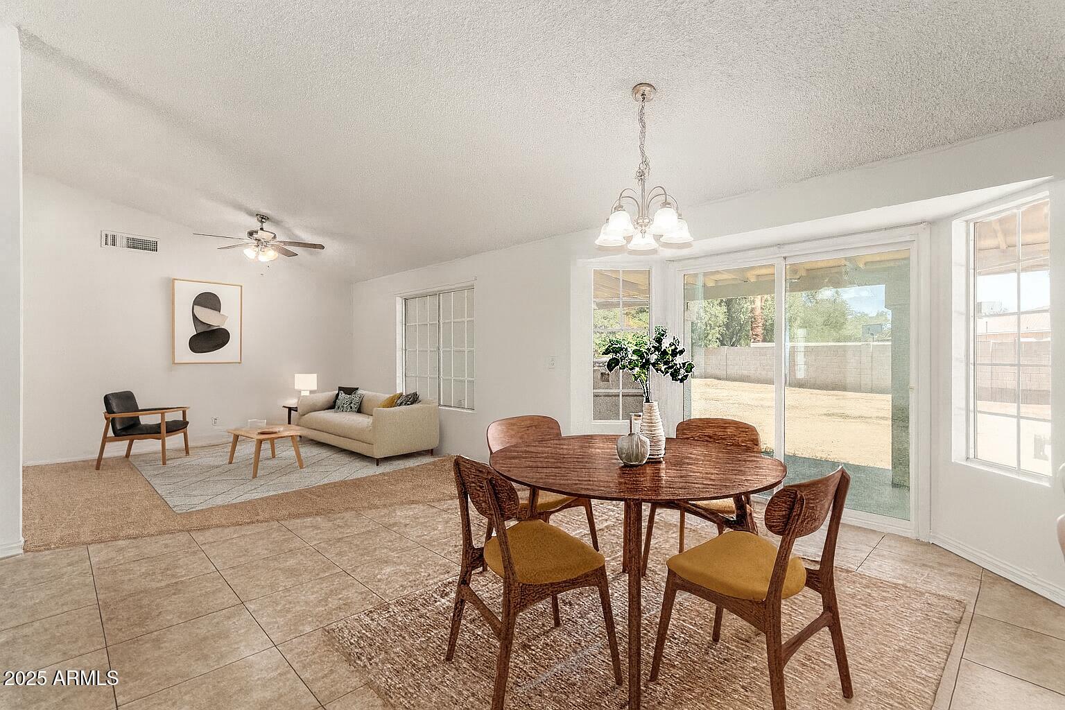3419 North 70th Avenue Phoenix, AZ 85033 - Photo 6 of 31 a view of a dining room with furniture and a chandelier