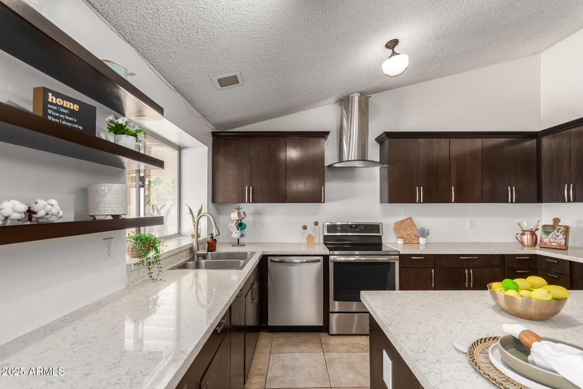 3419 North 70th Avenue Phoenix, AZ 85033 - Photo 9 of 31 a kitchen with stainless steel appliances a sink a stove top oven a counter space and cabinets